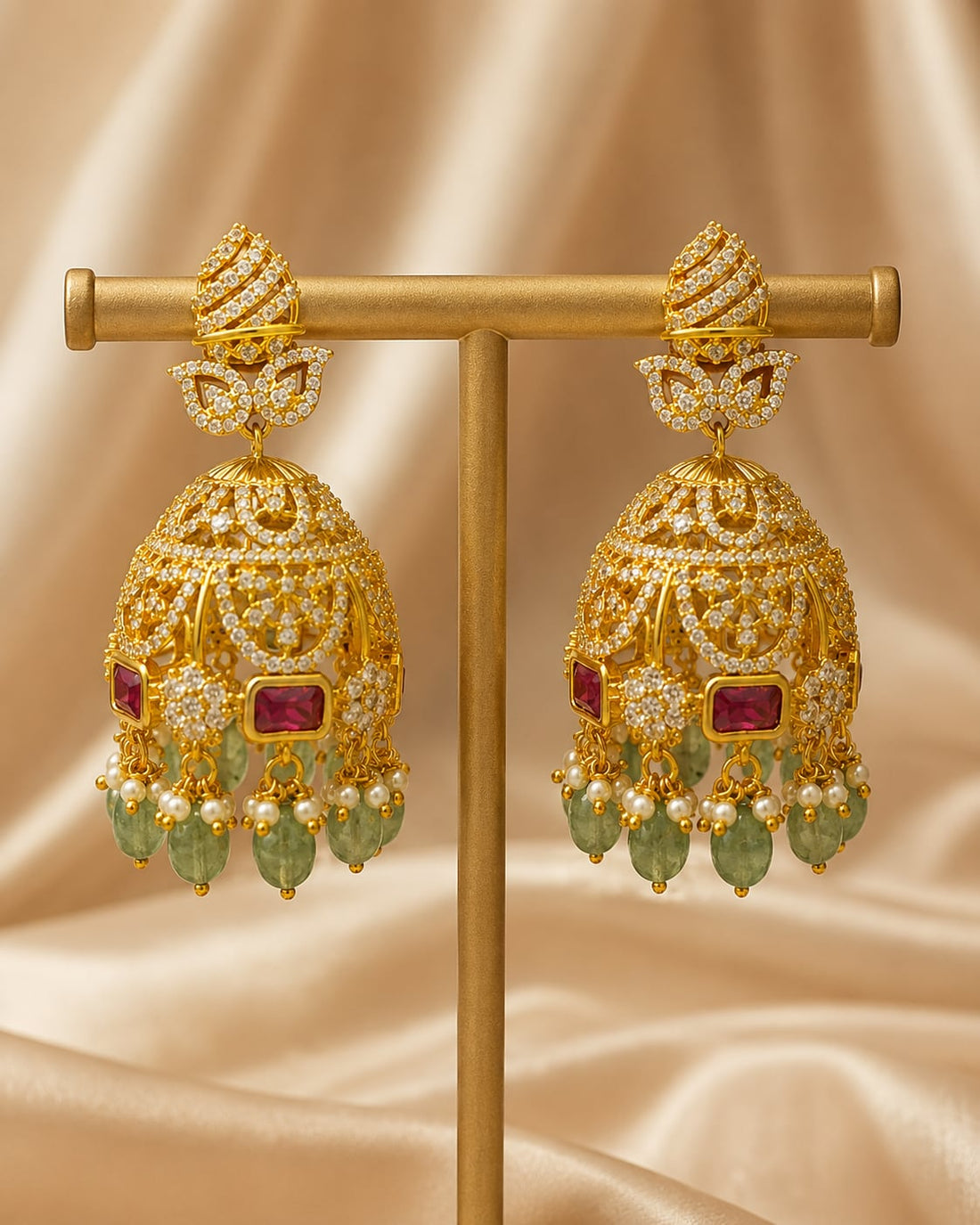 Front view of one matching pair of FeelOri gold-plated emerald-drop CZ leaf jhumka earrings