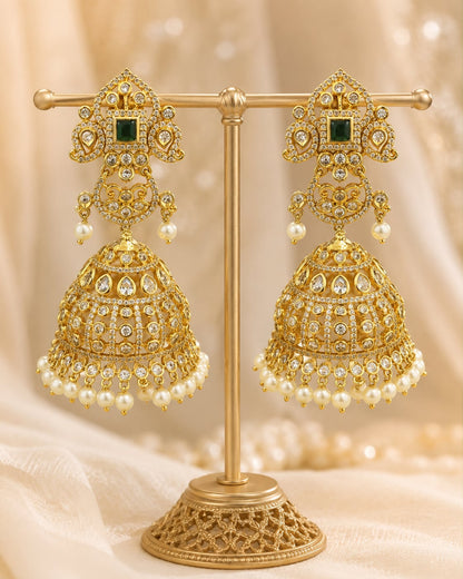 Front view of one matching pair of FeelOri grand gold-plated emerald CZ jhumka earrings with pearl-look fringe