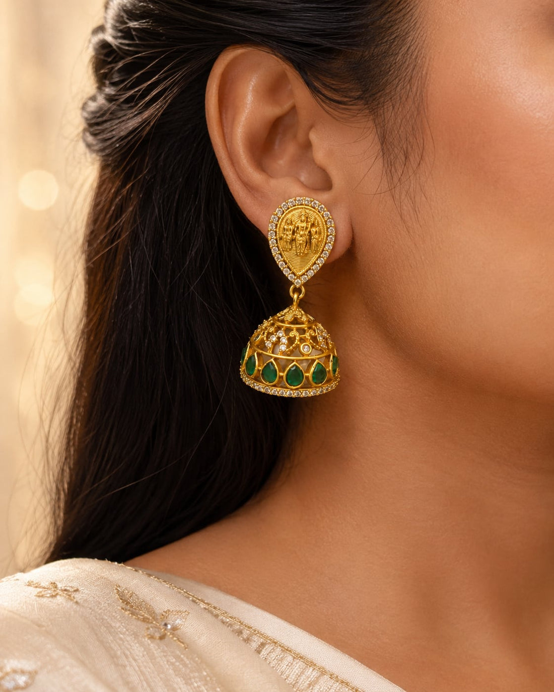 FeelOri gold-plated emerald jhumka earrings styled with Indian occasion wear
