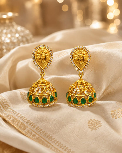 FeelOri gold-plated emerald jhumka earrings styled with saree fabric for Indian occasion wear