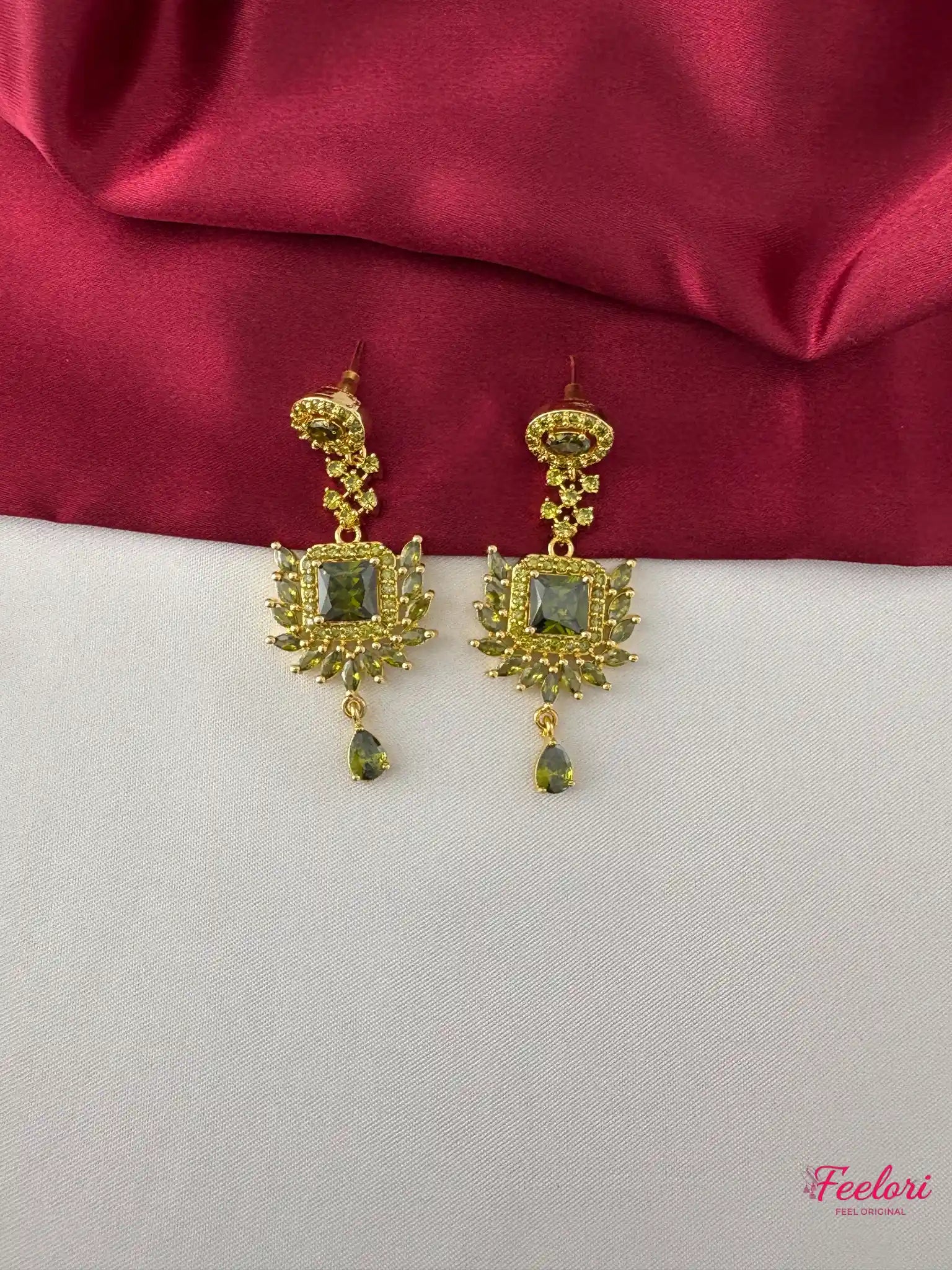 FeelOri Gold Plated Green Stone Earrings - Close-up view of the intricate earrings featuring square green stones and delicate tear-drop accents.