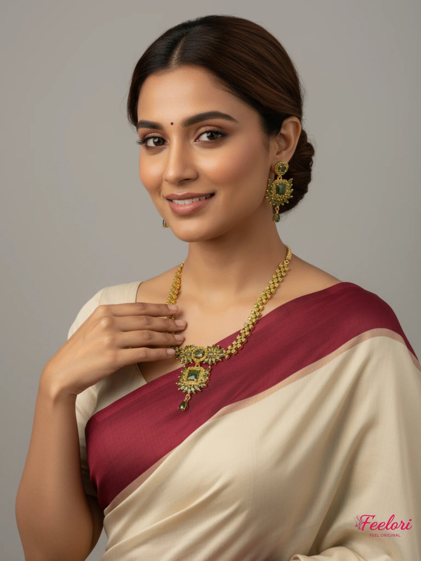 FeelOri Gold Plated Green Stone Regal Necklace Set - Model wearing set with elegant cream and maroon saree.
