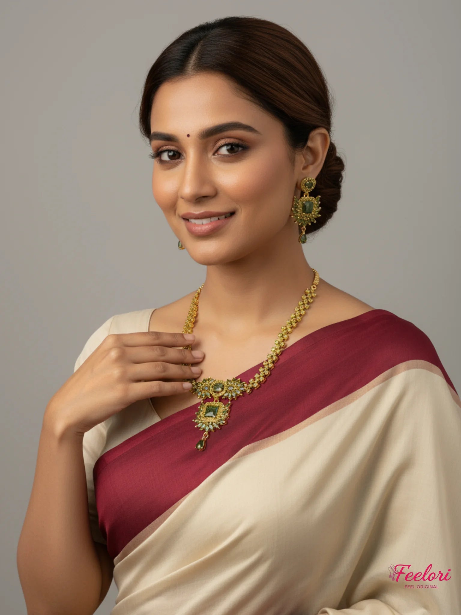 FeelOri Gold Plated Green Stone Regal Necklace Set - Model wearing set with elegant cream and maroon saree.