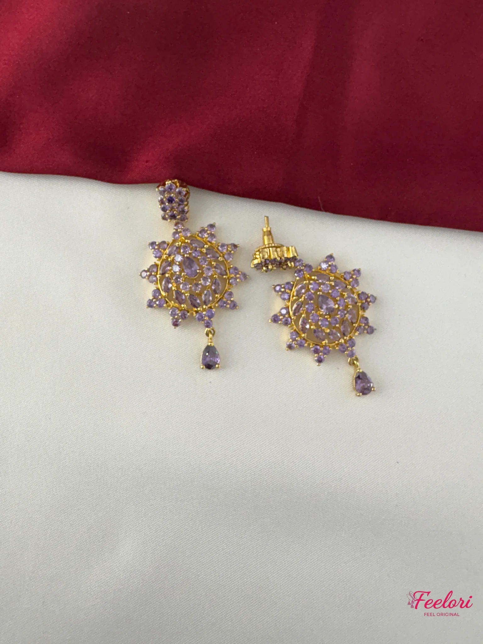 Close-up of FeelOri lavender-tone decorative stone peacock motif earrings with AD/CZ accents