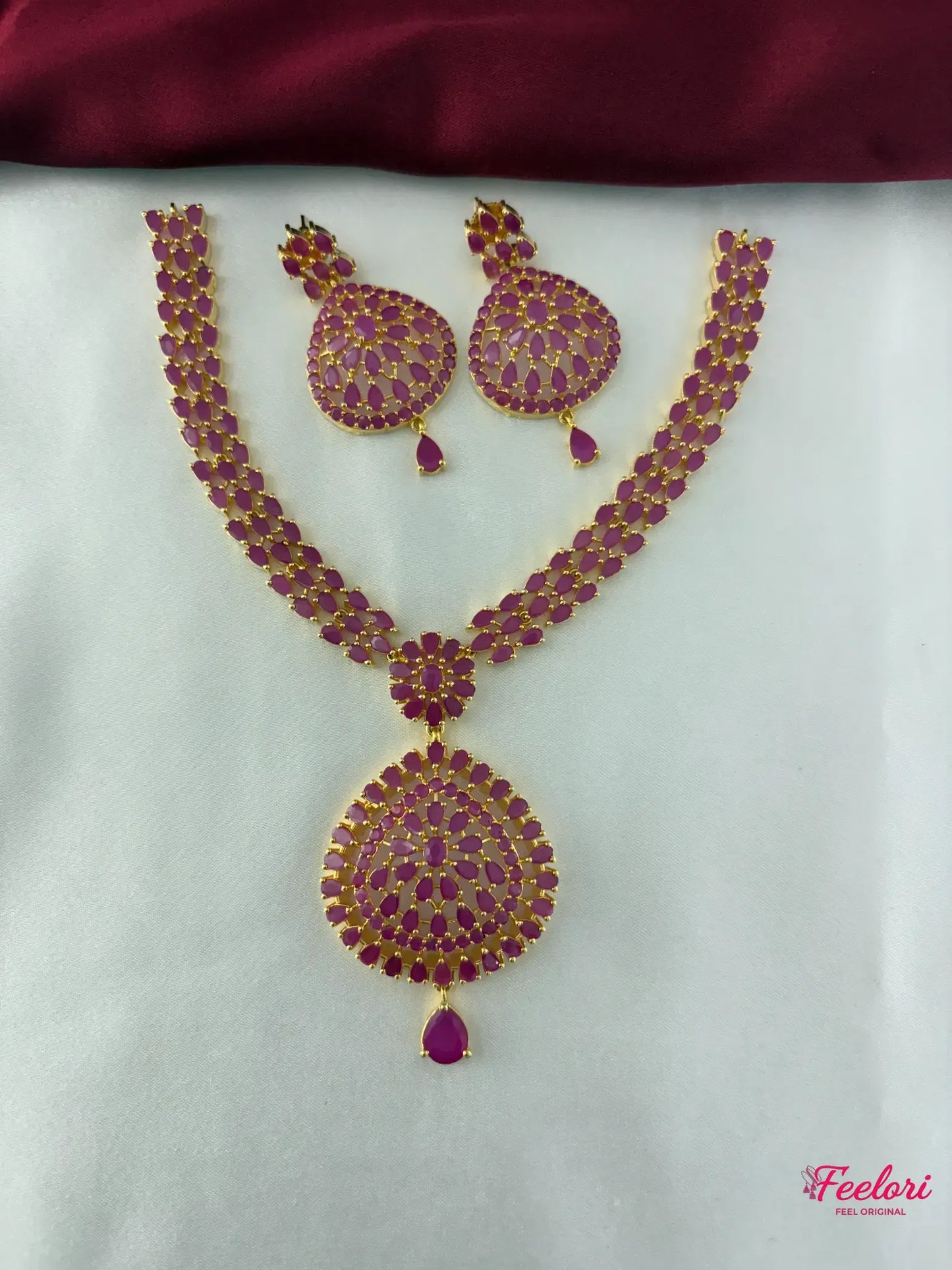FeelOri Gold Plated Ruby Drop Necklace Set - Main view showcasing the full necklace with its prominent teardrop pendant and matching earrings.