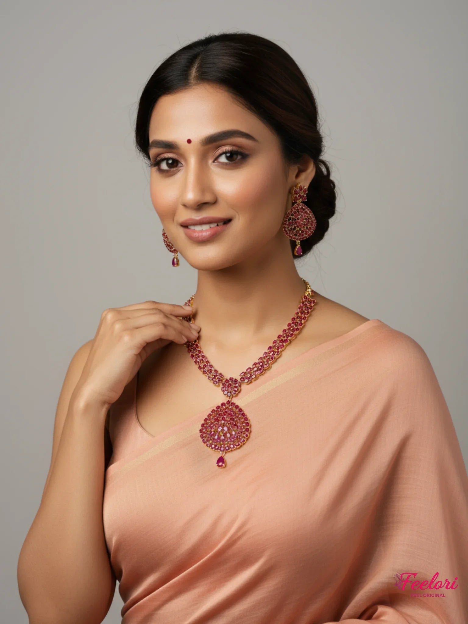 FeelOri Gold Plated Ruby Drop Necklace Set - Model wearing elegant set with traditional saree, smiling confidently.