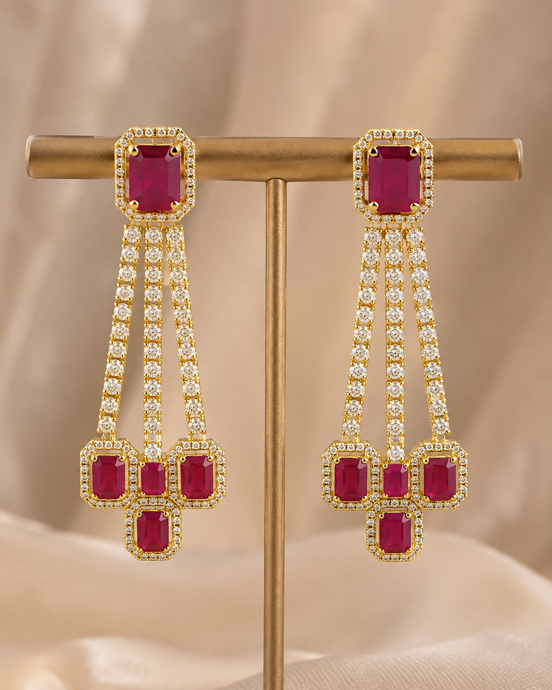 Front view of one matching pair of FeelOri gold-plated ruby linear CZ hanging earrings