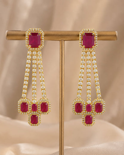Front view of one matching pair of FeelOri gold-plated ruby linear CZ hanging earrings