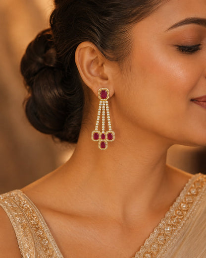 Model wearing FeelOri gold-plated ruby linear CZ hanging earrings for Indian occasion styling