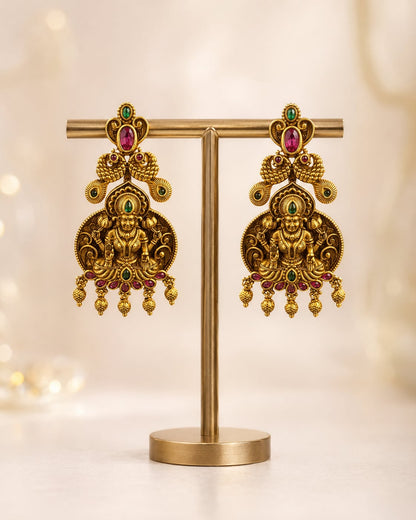 FeelOri gold-plated ruby and emerald earrings on jewellery display