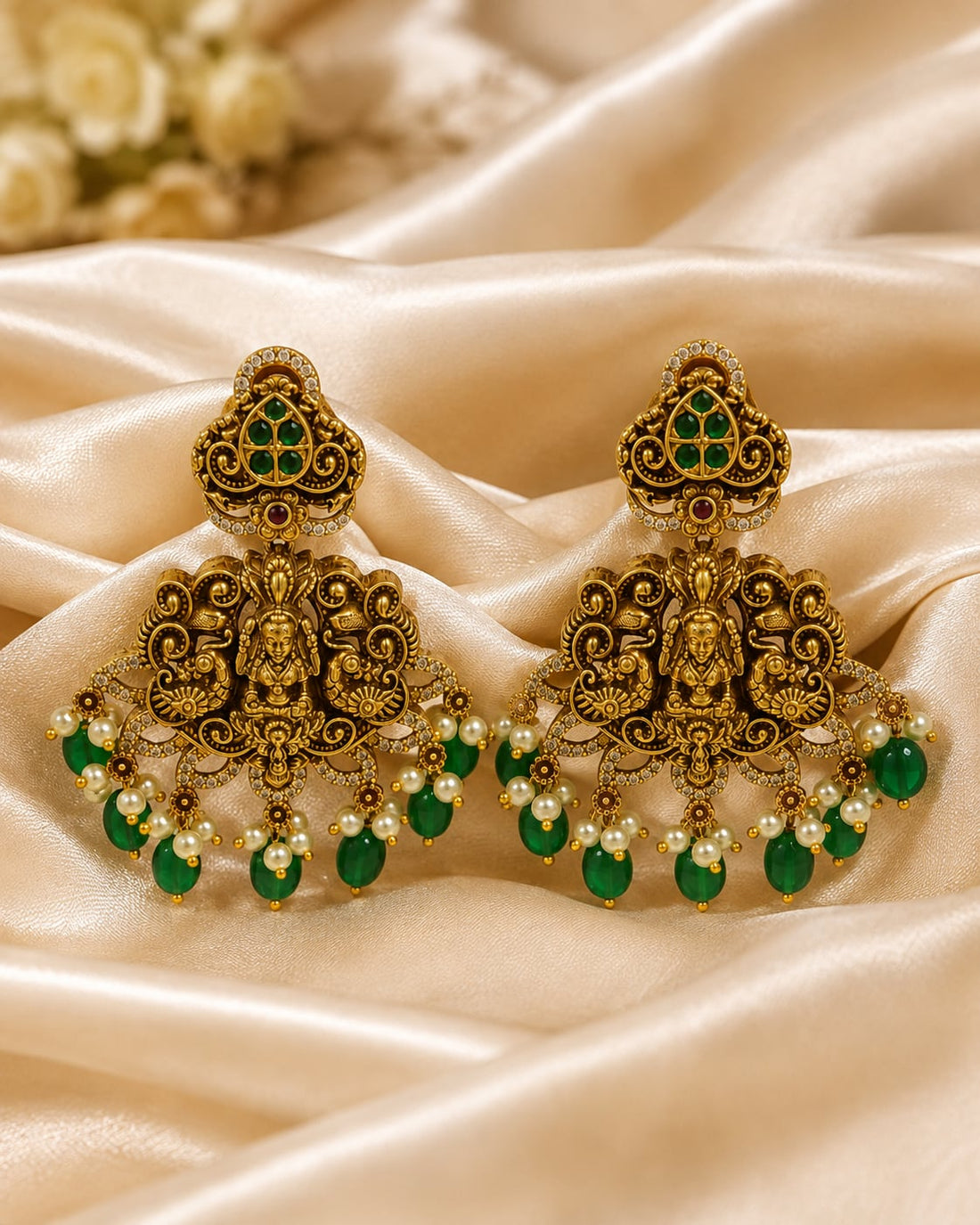 FeelOri gold-plated ruby and emerald earrings styled with saree fabric for Indian occasion wear