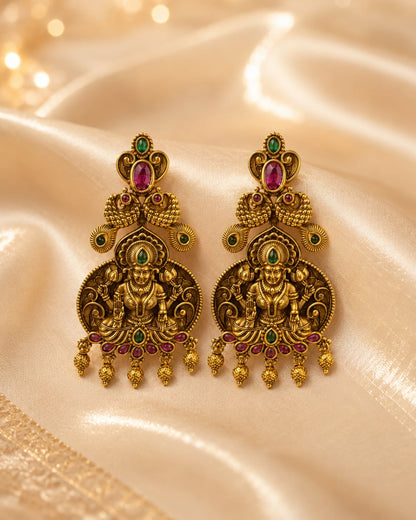 FeelOri gold-plated ruby and emerald earrings styled with saree fabric for Indian occasion wear