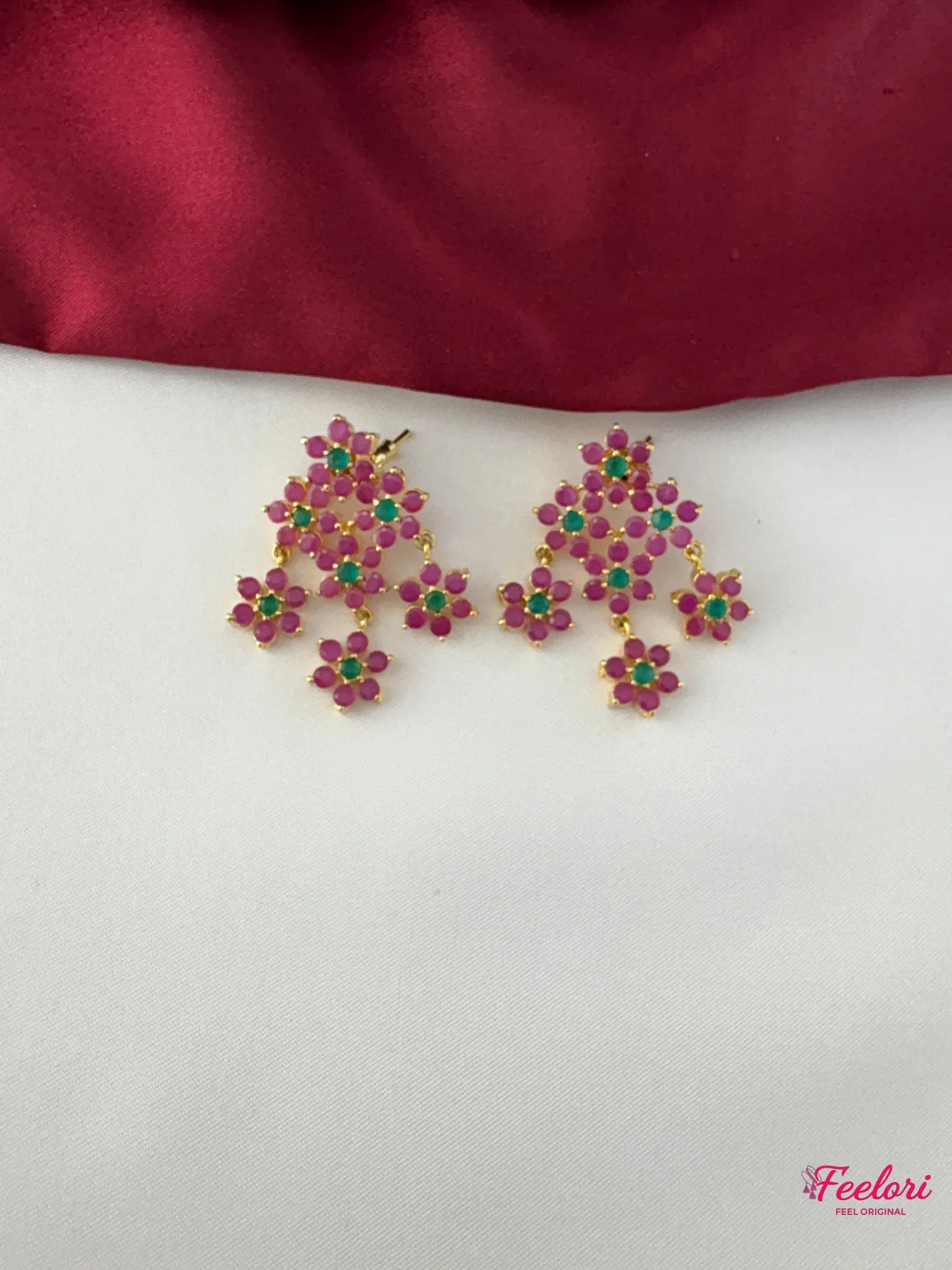 FeelOri Gold Plated Floral Ruby Emerald Earrings - Close-up view of the intricate chandelier earrings, highlighting the genuine ruby-like and emerald-like stones set in a delicate floral cluster design.