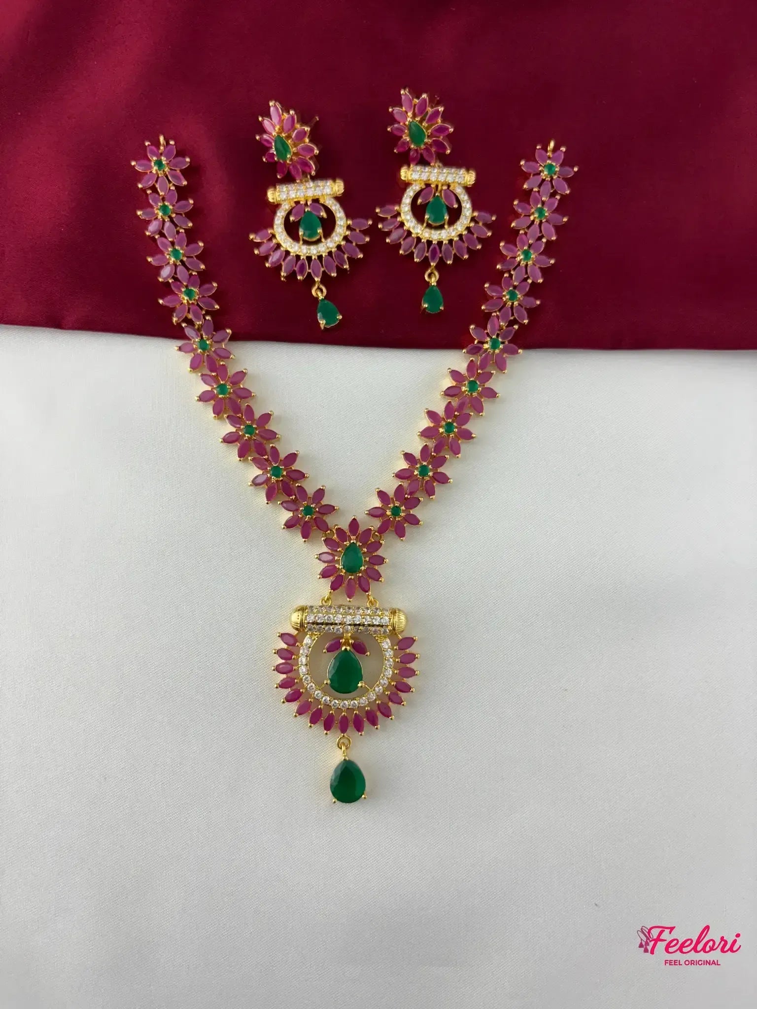 FeelOri Gold Plated Ruby & Emerald Floral Necklace Set - Full front view displaying the intricate flower-shaped linked chain and crescent pendant with a teardrop emerald-like stone.
