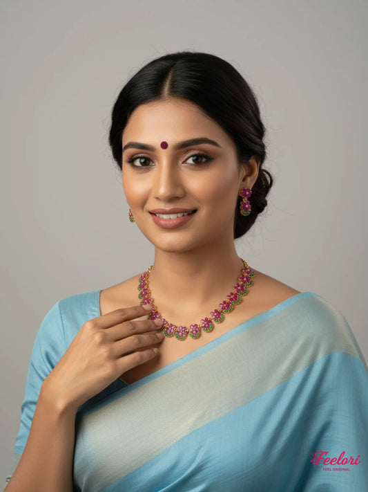 FeelOri Gold Plated Floral Ruby Emerald Necklace Set - Model wearing delicate cluster design with traditional blue saree.