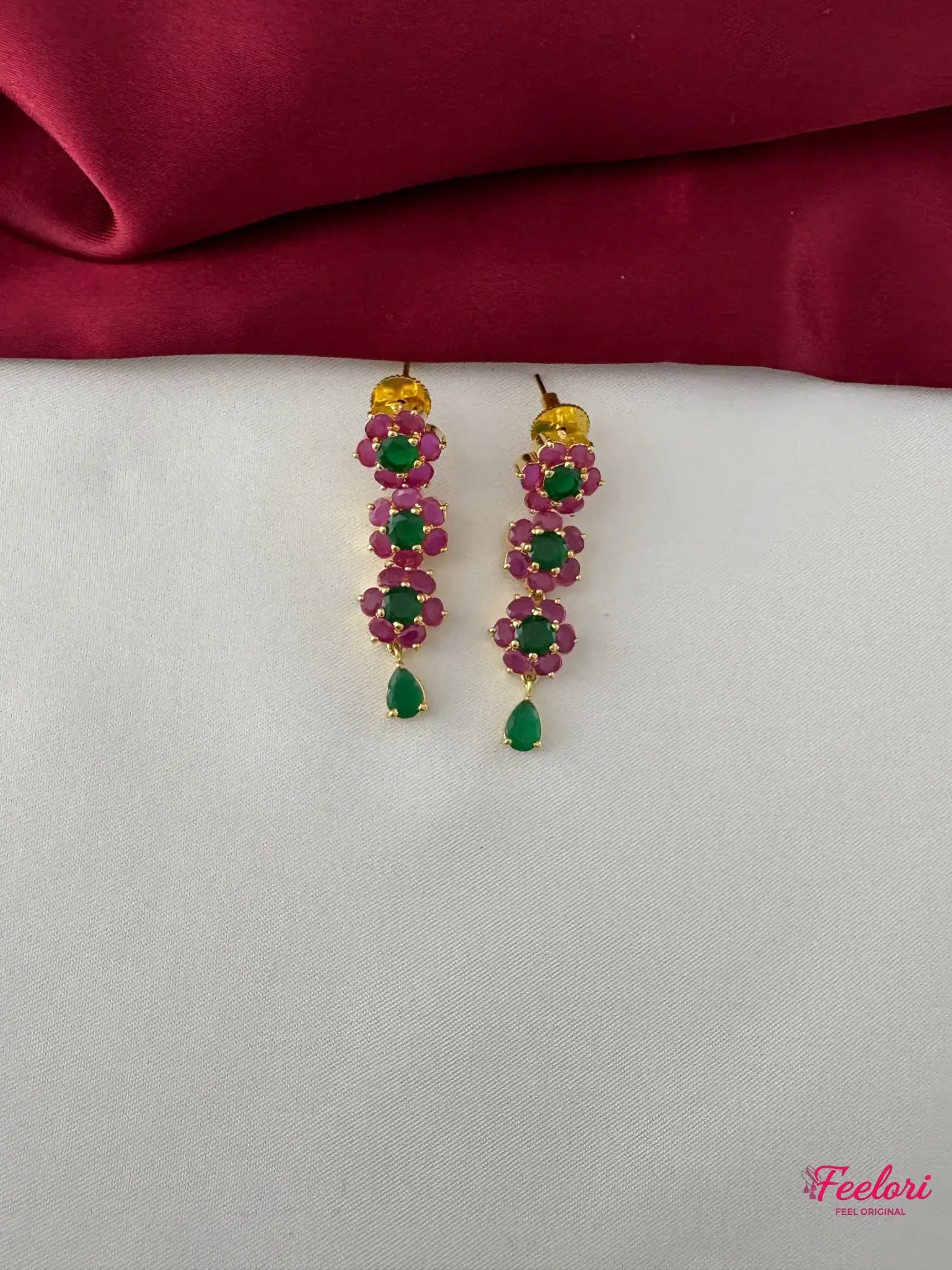 FeelOri Gold Plated Ruby Emerald Floral Petal Earrings - Close-up view of the dangle earrings, highlighting the Ruby CZ and emerald petal design and teardrop drop.