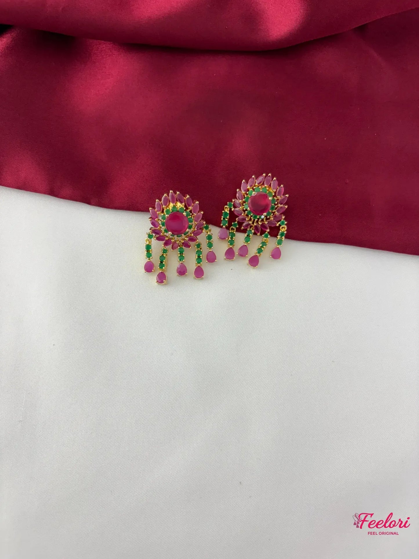 FeelOri Gold Plated Ruby Emerald Floral Petal Earrings - Close-up view highlighting the detailed floral stud and vibrant emerald and ruby dangling stone drops.