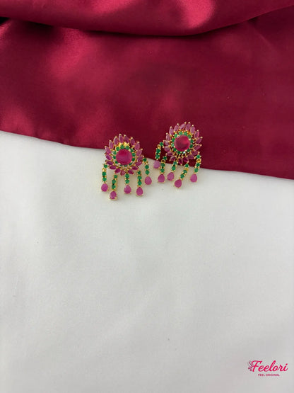 FeelOri Gold Plated Ruby Emerald Floral Petal Earrings - Close-up view highlighting the detailed floral stud and vibrant emerald and ruby dangling stone drops.