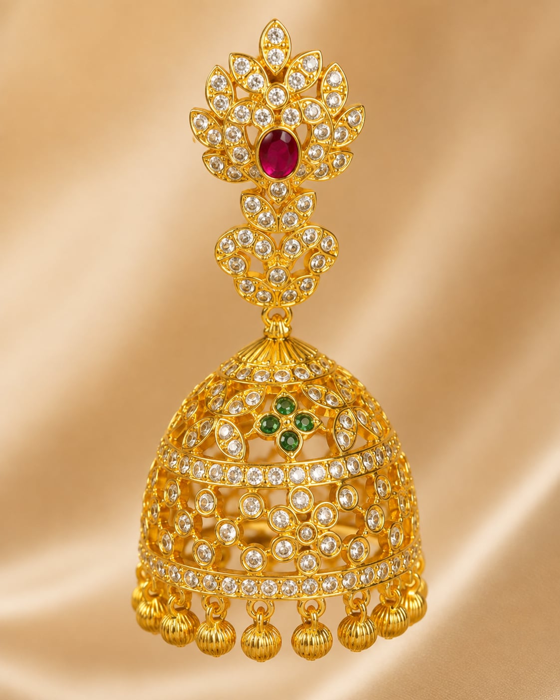 Close-up of clear CZ settings, ruby centres, emerald accents and gold bead fringe