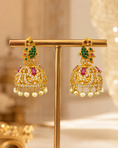 FeelOri gold-plated ruby emerald floral CZ jhumka earrings displayed as a matching pair