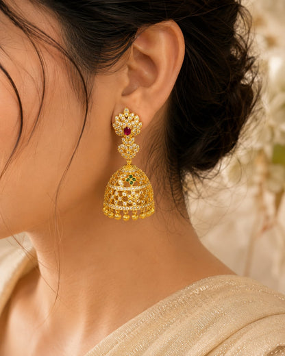 Model wearing FeelOri gold-plated CZ jhumka earrings with ruby and emerald accents