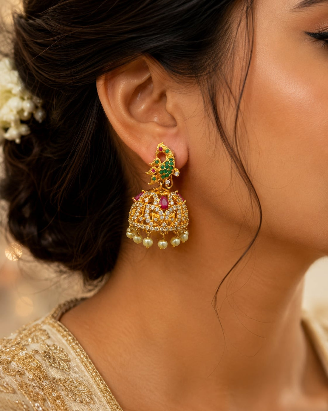 Model wearing FeelOri gold-plated ruby emerald floral CZ jhumka earrings for Indian occasion styling