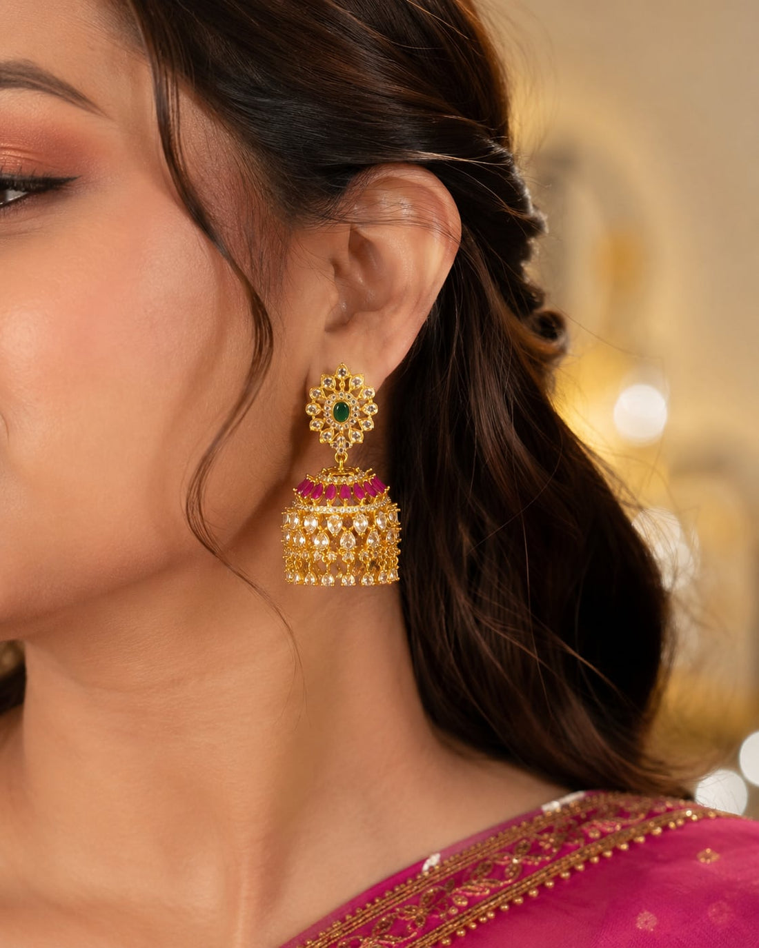Model wearing FeelOri gold-plated ruby emerald floral-dome CZ jhumka earrings for Indian occasion styling