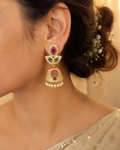 Model wearing FeelOri petite gold-plated ruby emerald butterfly CZ jhumka earrings for Indian occasion styling