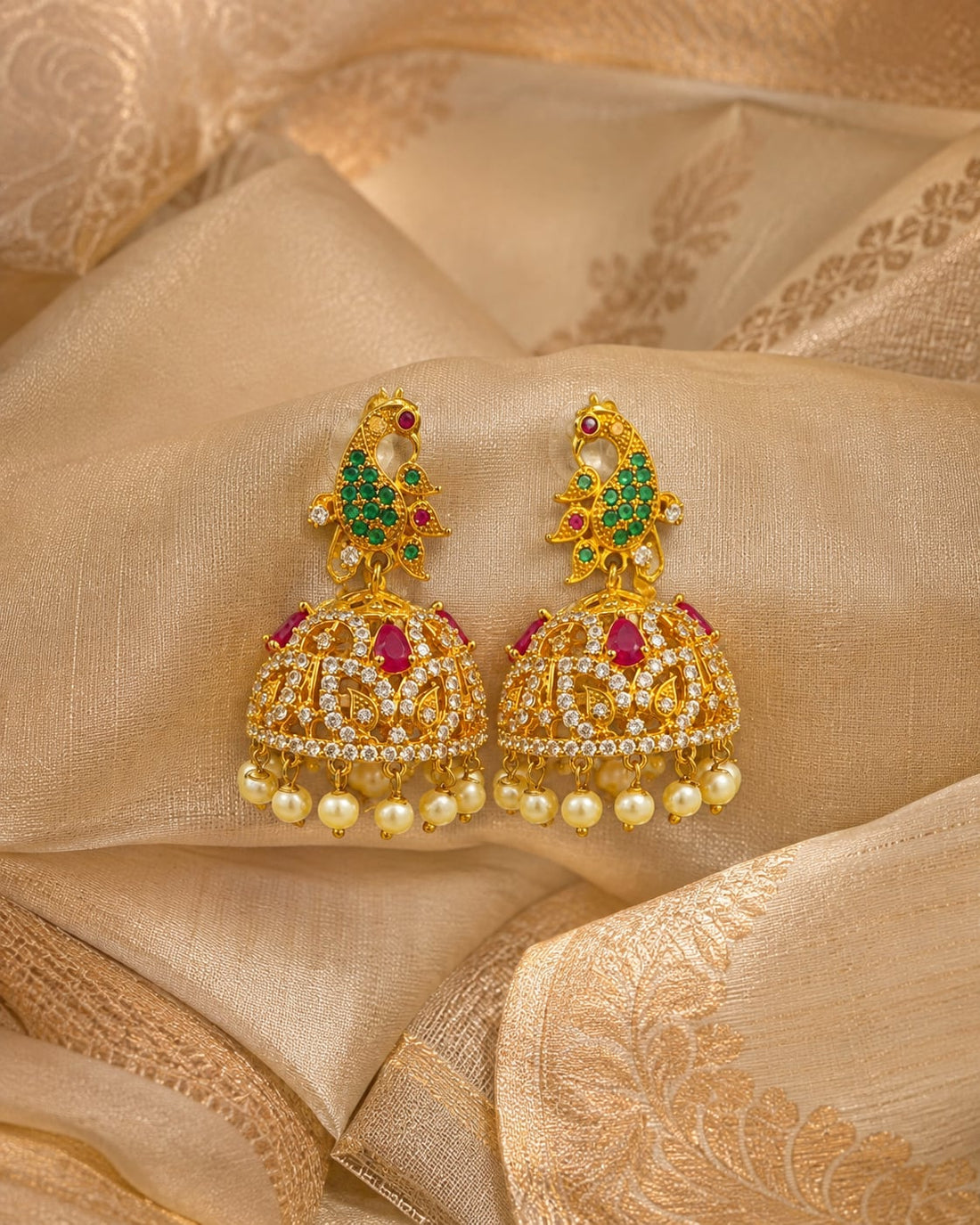 FeelOri gold-plated ruby emerald floral CZ jhumka earrings styled with saree fabric