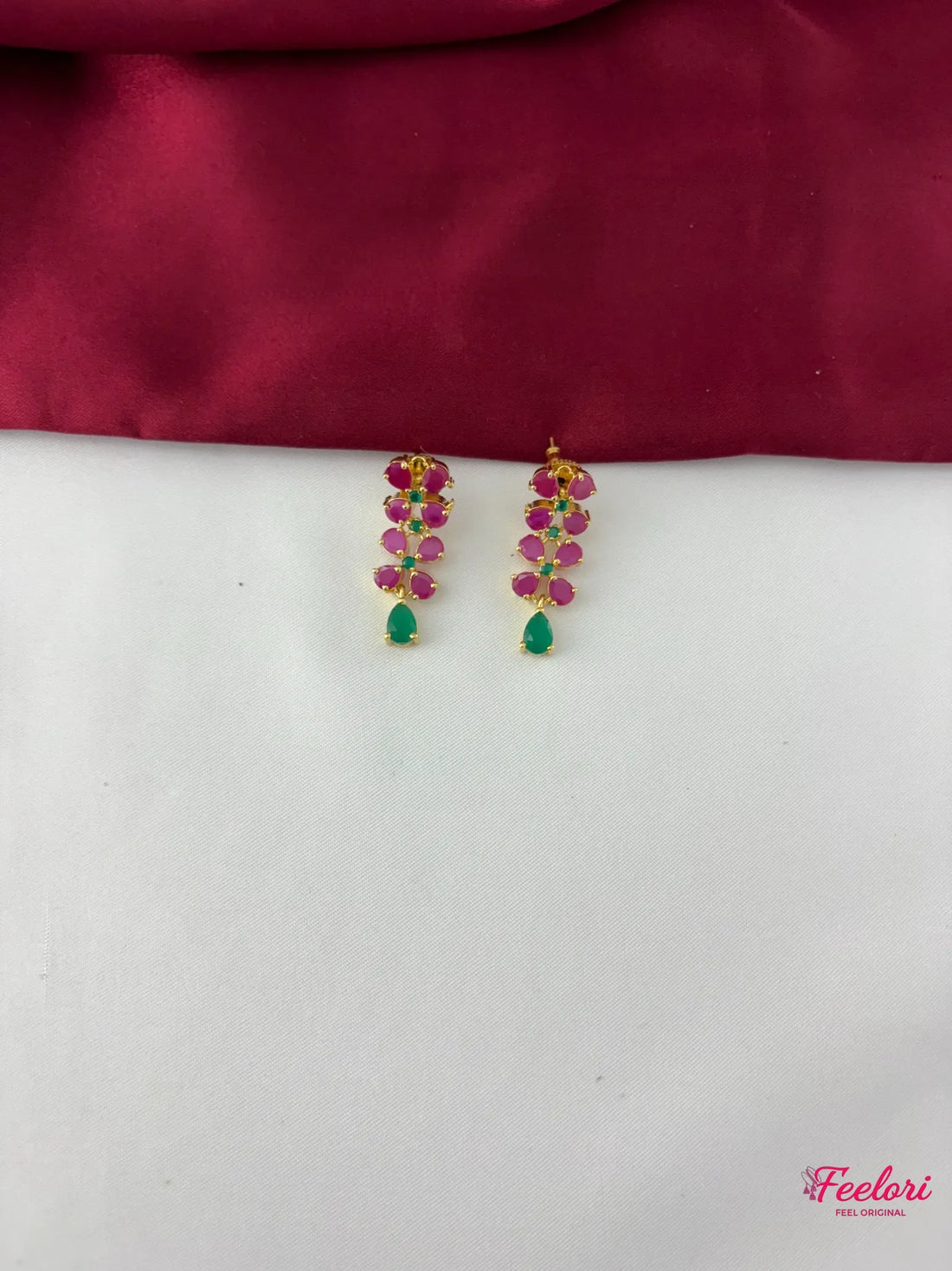 FeelOri Gold Plated Ruby Emerald Leaf Motif Earrings - Close-up view of the matching earrings featuring a graceful cluster of Ruby CZ and emerald stones.