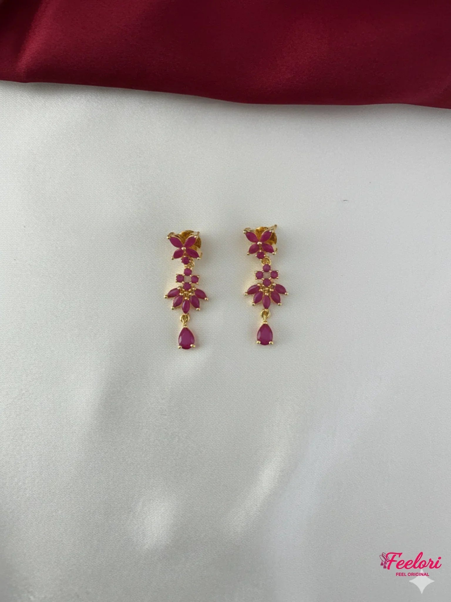 FeelOri Gold Plated Ruby Floral Earrings - Close-up view of the matching floral drop earrings with Ruby CZ-hued stones and push-back findings.