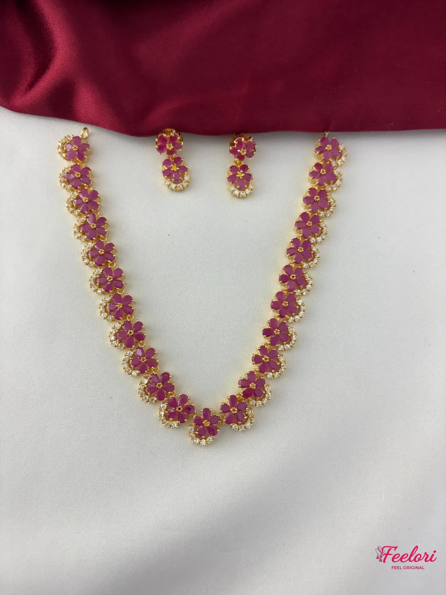 FeelOri Gold Plated Ruby Floral Motif Necklace Set - Full front view showcasing the elegant design of ruby flower clusters and matching earrings.