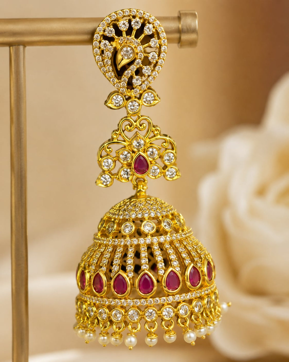 Close-up of clear CZ settings, ruby accents and pearl-look fringe