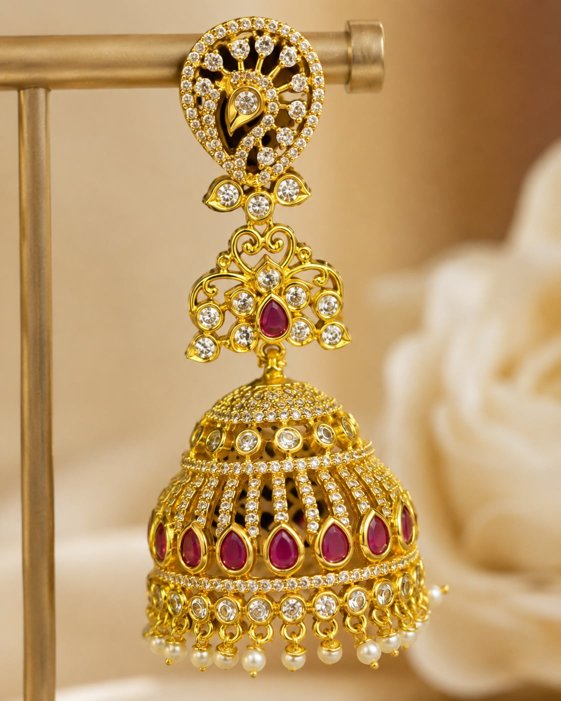 Close-up of clear CZ settings, ruby accents and pearl-look fringe