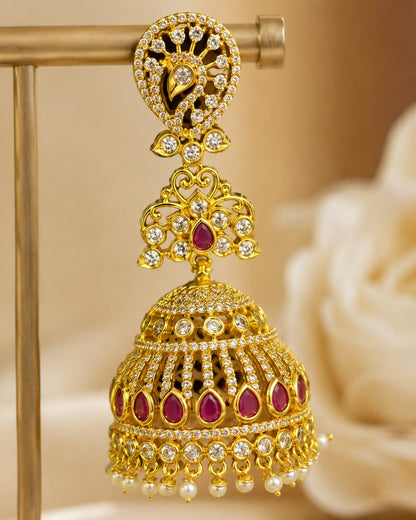 Close-up of clear CZ settings, ruby accents and pearl-look fringe