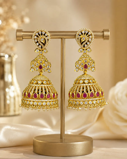 FeelOri gold-plated long CZ jhumka earrings with ruby accents and pearl-look fringe