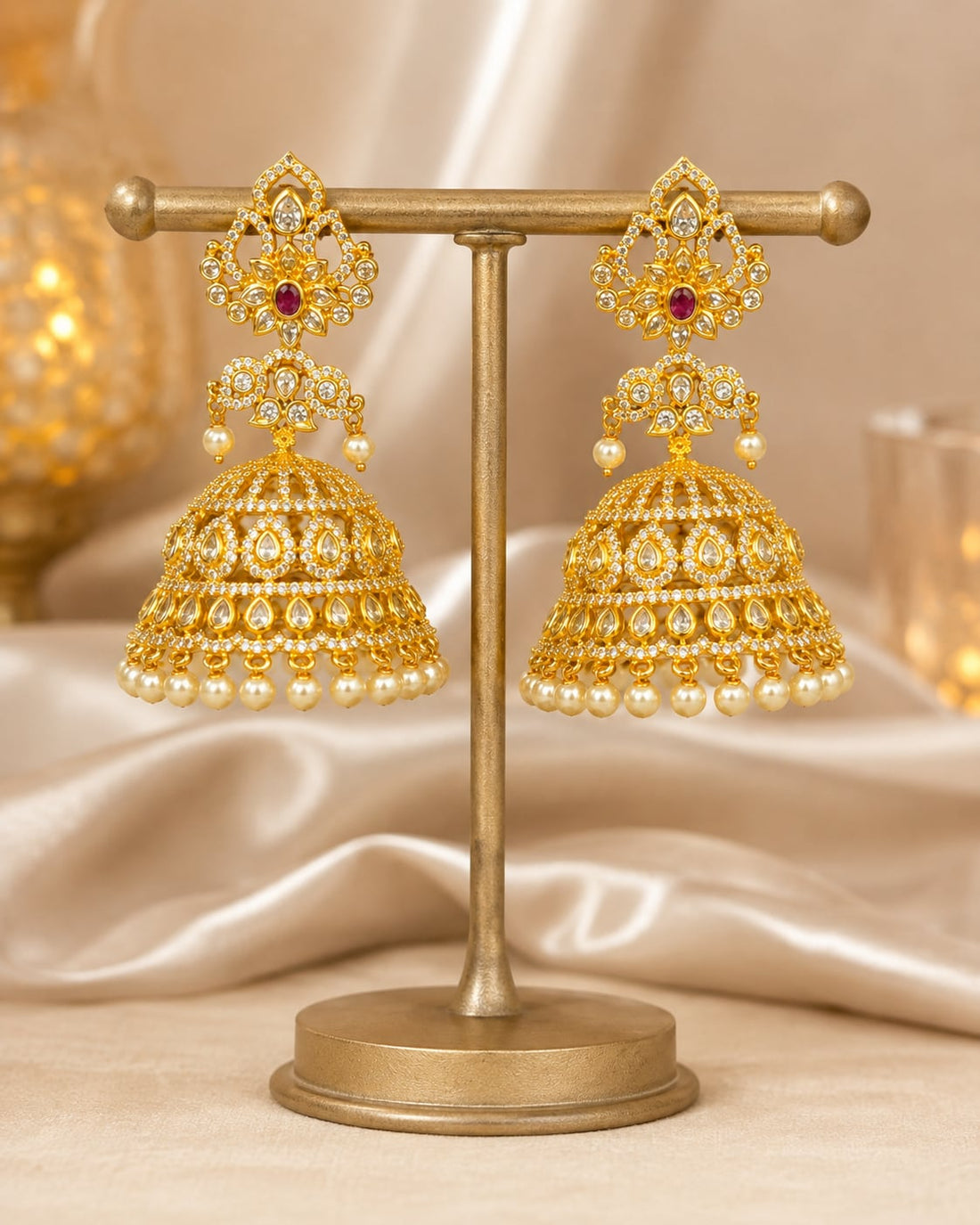FeelOri grand gold-plated CZ jhumka earrings with ruby accents and pearl-look fringe