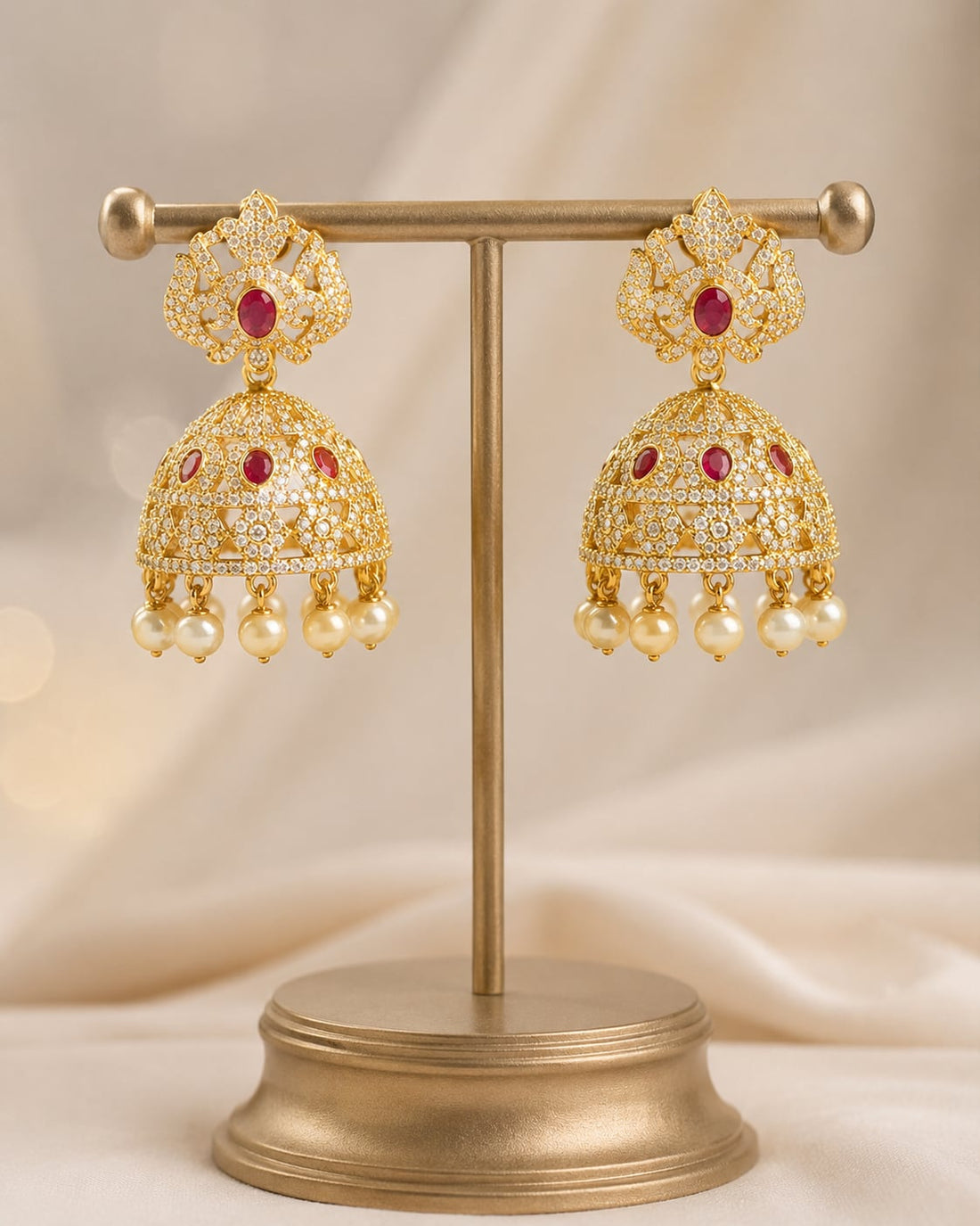 FeelOri gold-plated ruby crown CZ jhumka earrings with pearl-look fringe displayed as a matching pair