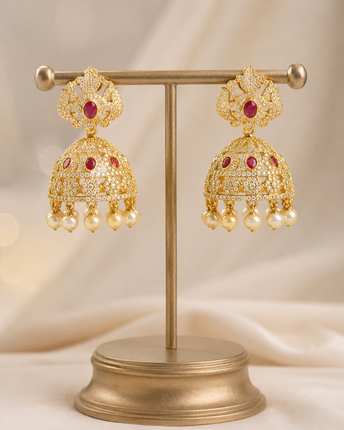 FeelOri gold-plated ruby crown CZ jhumka earrings with pearl-look fringe displayed as a matching pair