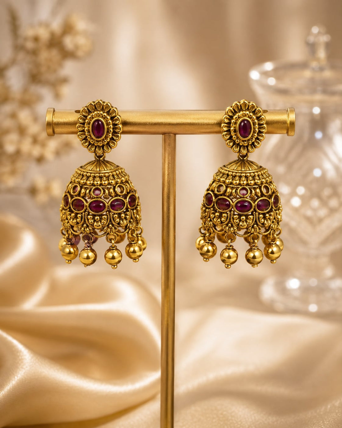 FeelOri gold-plated ruby jhumka earrings on jewellery display