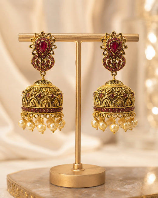 FeelOri gold-plated ruby jhumka earrings on jewellery display