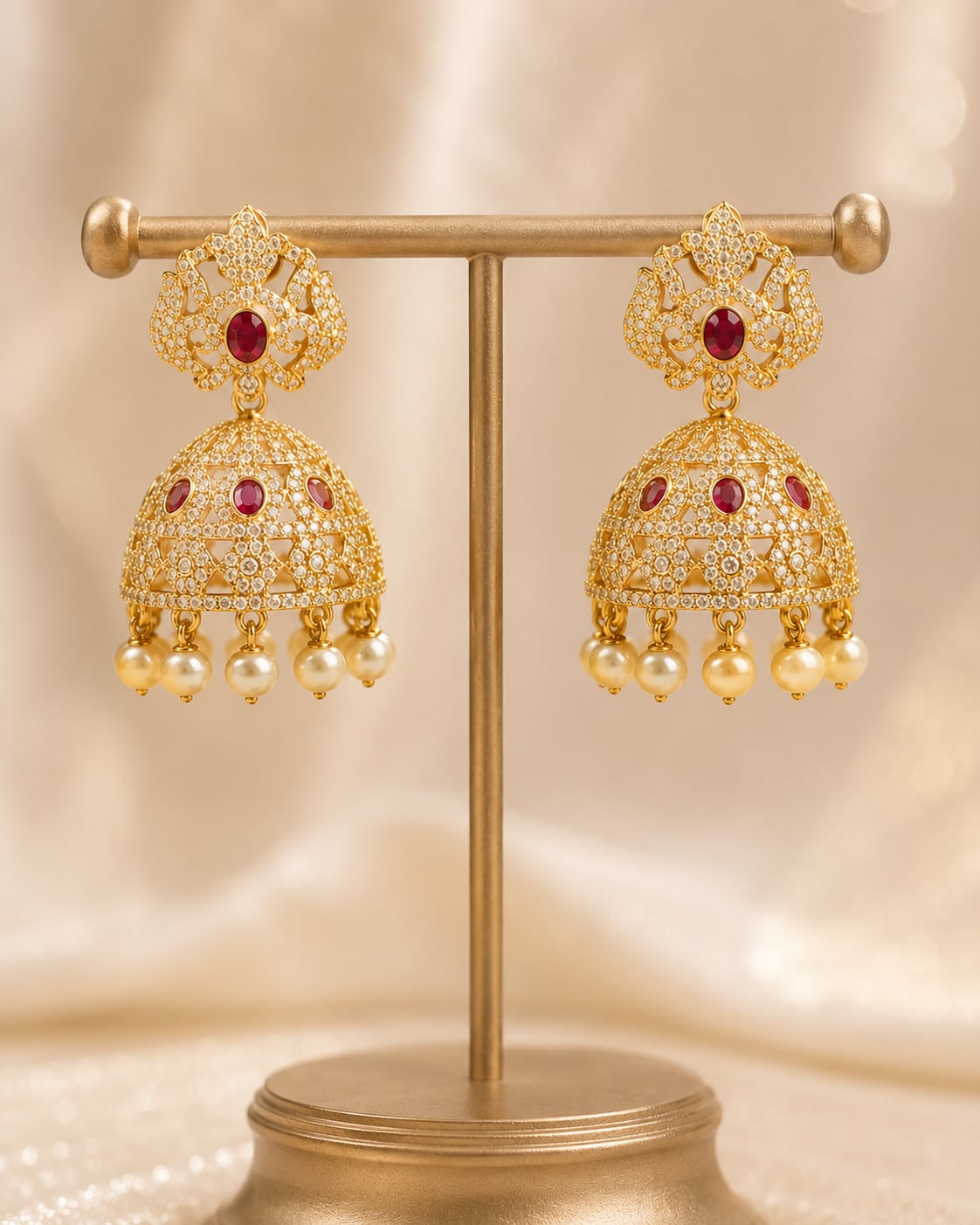 Front view of one matching pair of FeelOri gold-plated ruby crown CZ jhumka earrings with pearl-look fringe