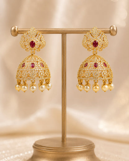 Front view of one matching pair of FeelOri gold-plated ruby crown CZ jhumka earrings with pearl-look fringe
