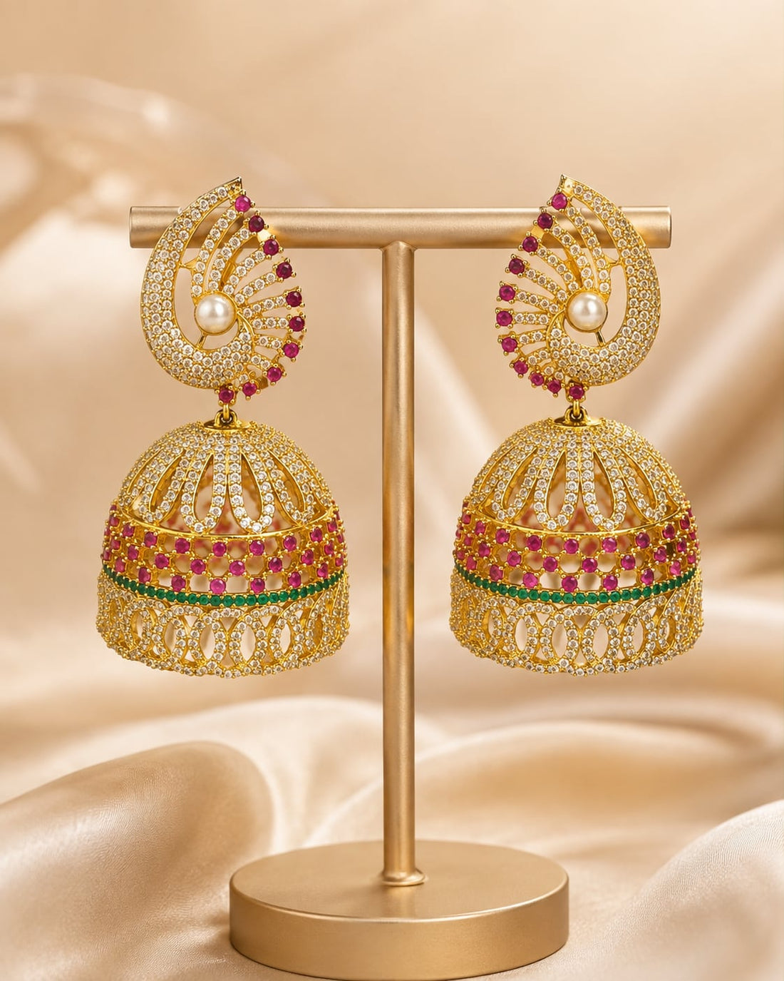 Front view of one matching pair of FeelOri gold-plated ruby fan CZ jhumka earrings with pearl-look drops