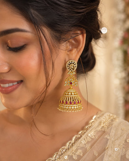 Model wearing FeelOri long gold-plated CZ jhumka earrings with ruby accents