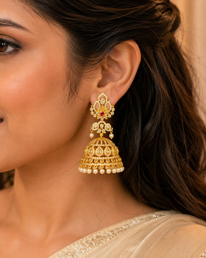 Model wearing FeelOri grand gold-plated CZ jhumka earrings with ruby accents