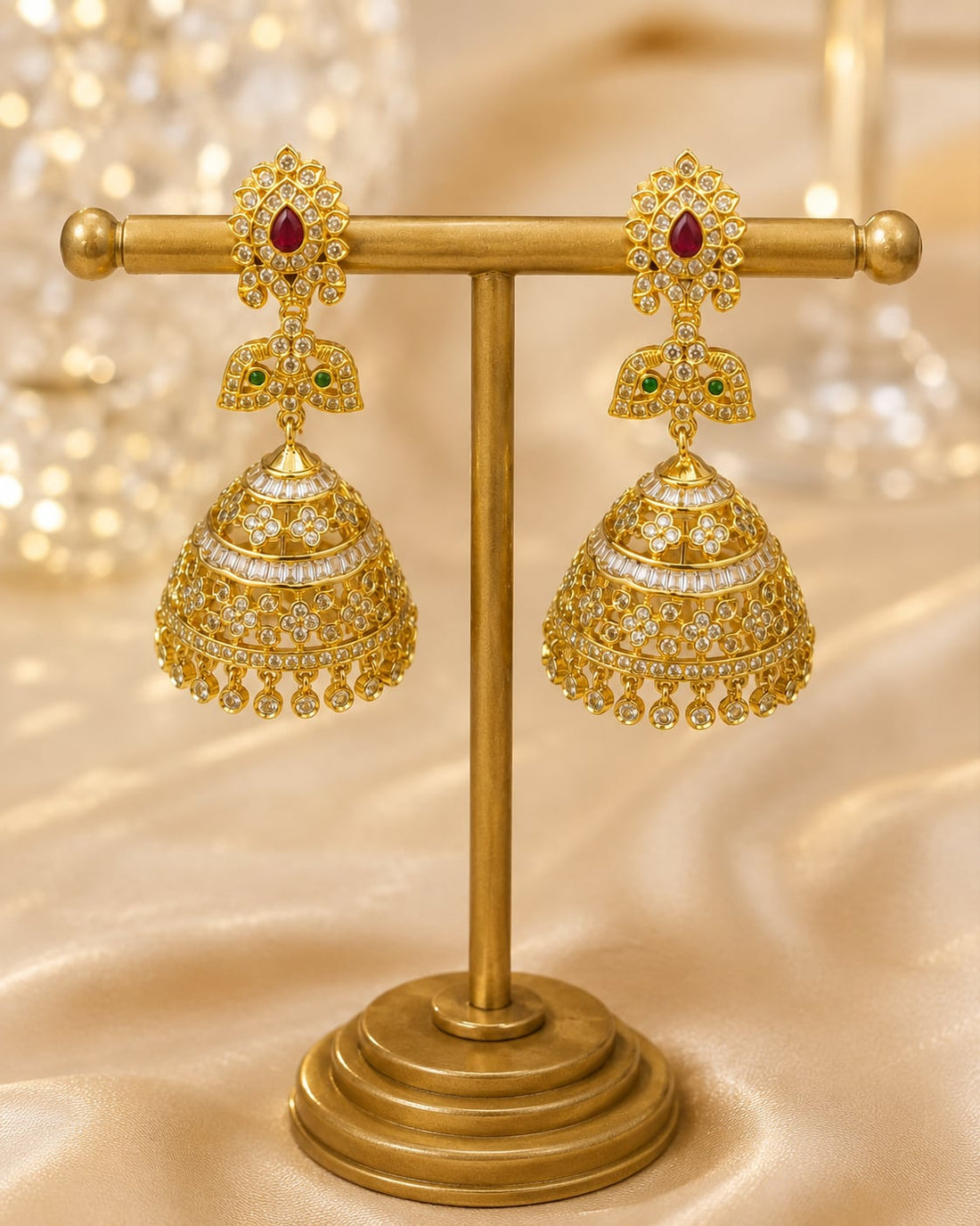 Model wearing FeelOri gold-plated ruby butterfly CZ jhumka earrings with pearl-look fringe for Indian occasion styling