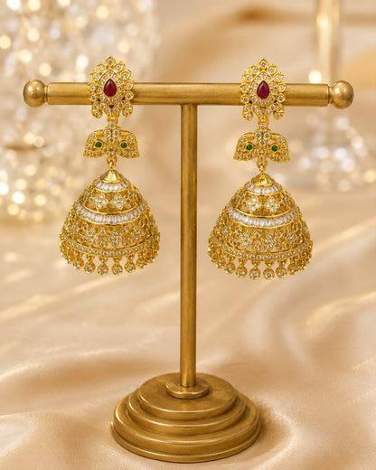 Model wearing FeelOri gold-plated ruby butterfly CZ jhumka earrings with pearl-look fringe for Indian occasion styling