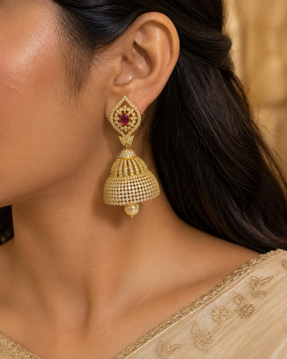 Model wearing FeelOri gold-plated ruby paisley CZ bell jhumka earrings for Indian occasion styling