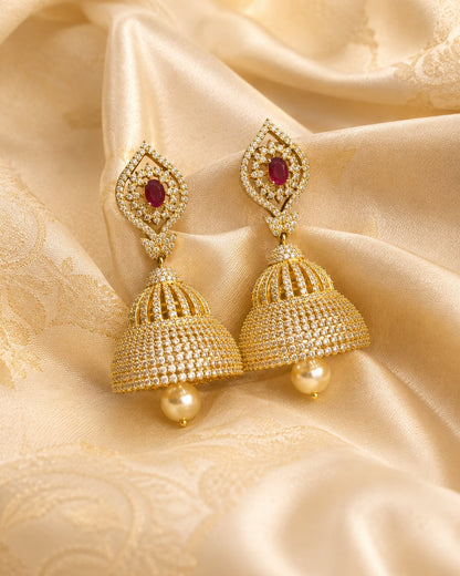 FeelOri gold-plated ruby paisley CZ bell jhumka earrings styled with saree fabric